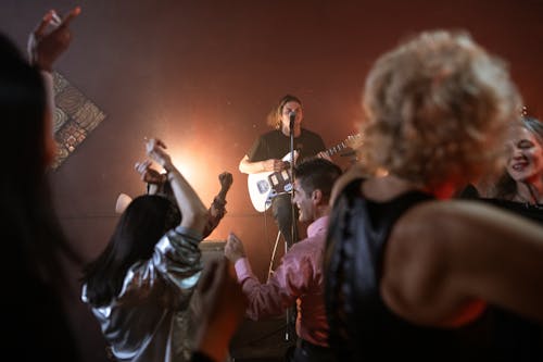 A guitarist performing to a pub audience